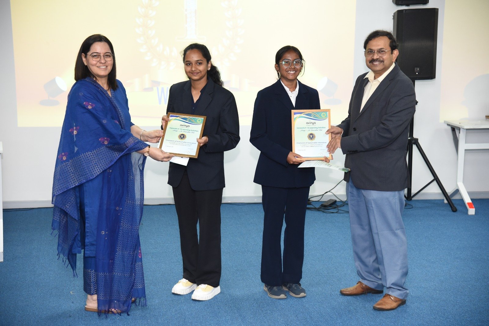 Rohini Mahajan (left), Cluster Head – Operations, Veranda K-12, Chitrashree C (second from left) and Divyanshi Soo (centre) from Deeksha STEM School, Bengaluru and Prof. Debabrata Das, Director, IIIT-Bangalore